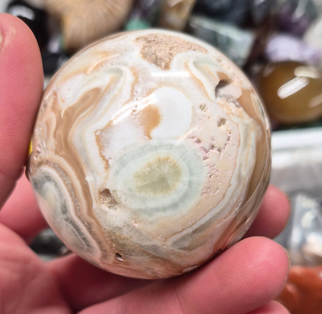 Banded Green Onyx/Caribbean Calcite sphere–55mm