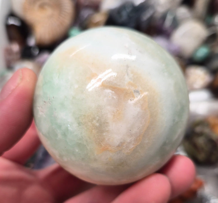 Banded Green Onyx/Caribbean Calcite sphere–55mm