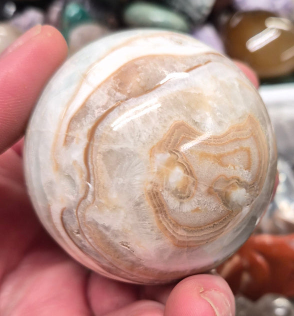 Banded Green Onyx/Caribbean Calcite sphere–55mm