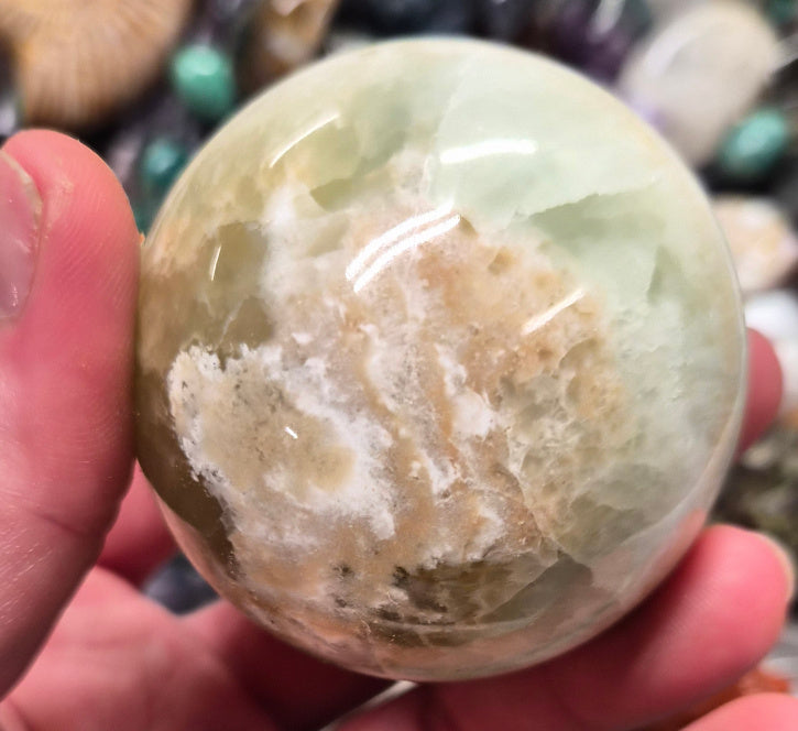 Banded Green Onyx/Caribbean Calcite sphere–55mm