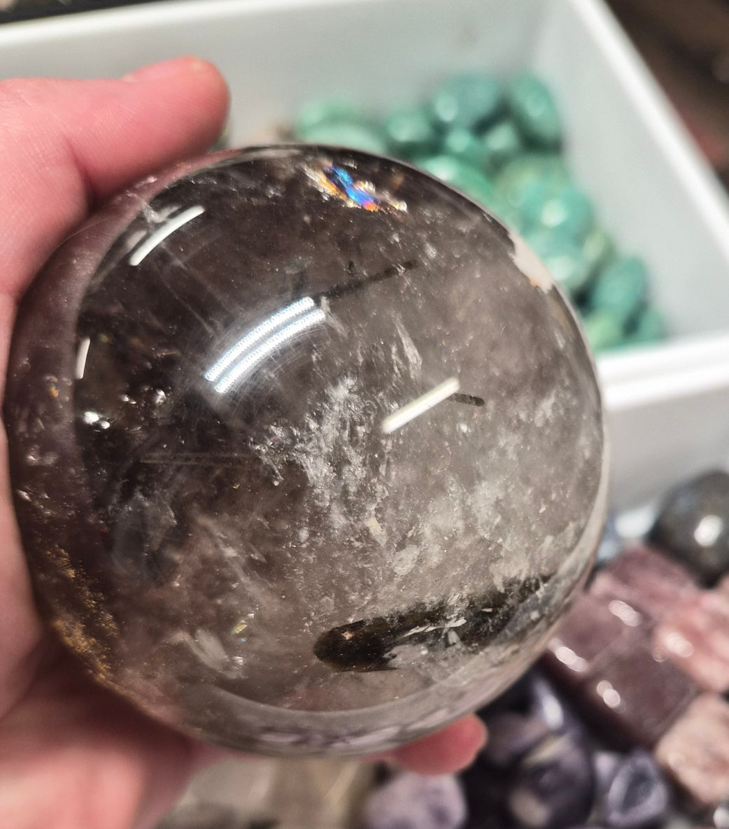 Smoky Quartz Sphere with Black Tourmaline Inclusions and a massive Rainbow Flash– 85mm