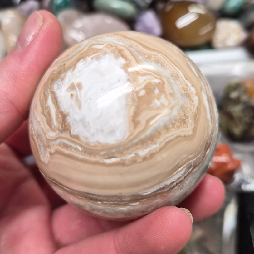 Banded Green Onyx/Caribbean Calcite sphere–55mm